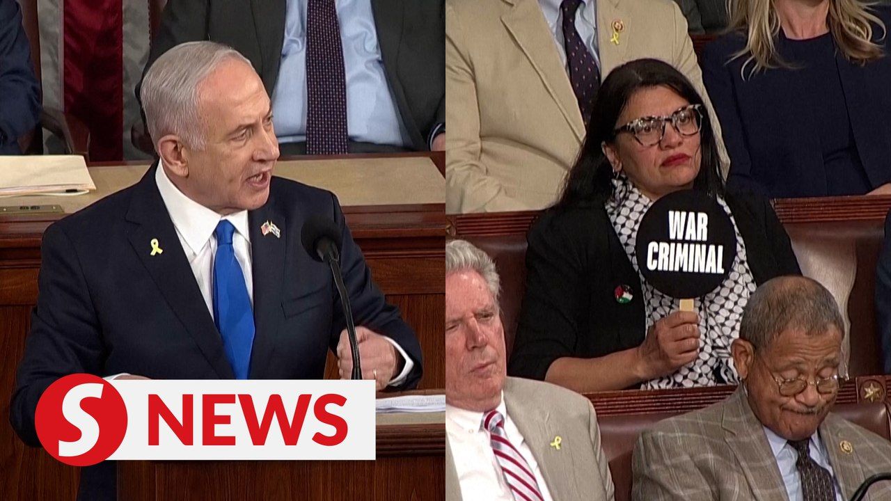 Rep. Rashida Tlaib holds 'war criminal' sign as Netanyahu speaks ...